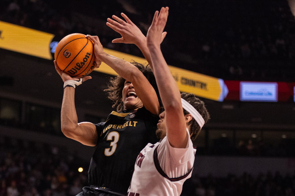 Vanderbilt guard Tyler Tanner (3) shoots on South Carolina forward Jordan Butler (0) during the first half of an NCAA college basketball game, Saturday, Jan. 3, 2026, in Columbia, N.C. (AP Photo/Scott Kinser)