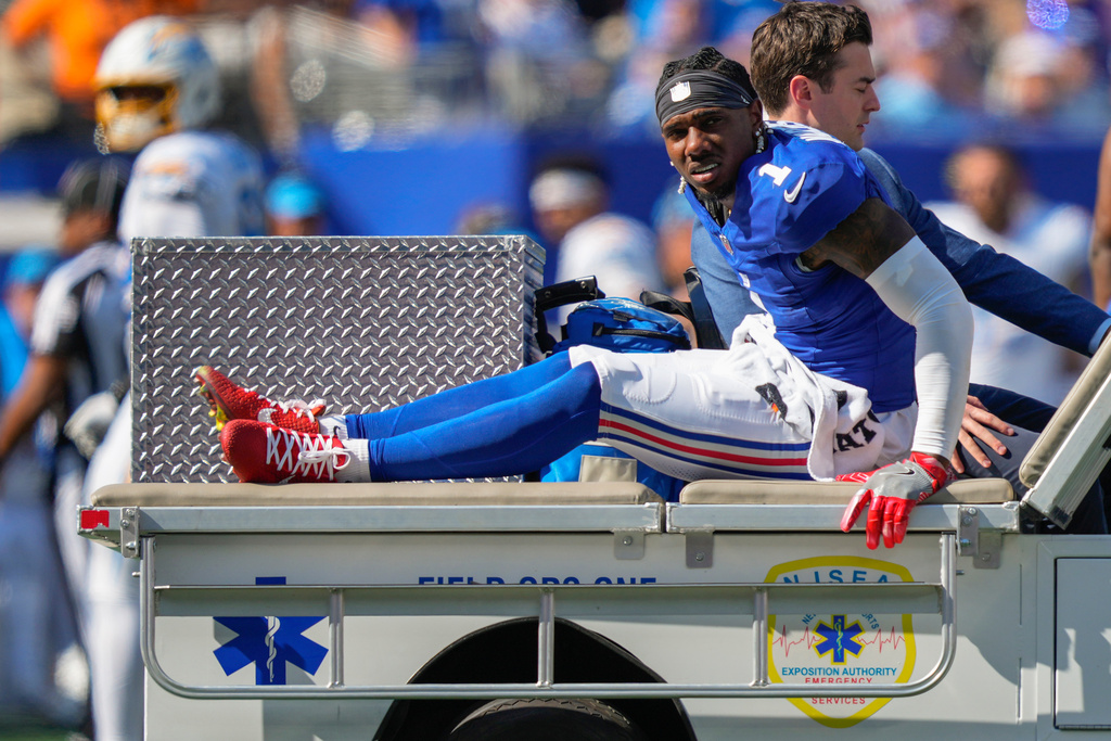 New York Giants wide receiver Malik Nabers (1) is driven off the field by medical personnel after an injury during the second quarter of an NFL football game against the Los Angeles Chargers, Sunday, Sept. 28, 2025, in East Rutherford, N.J. (AP Photo/Yuki Iwamura)
