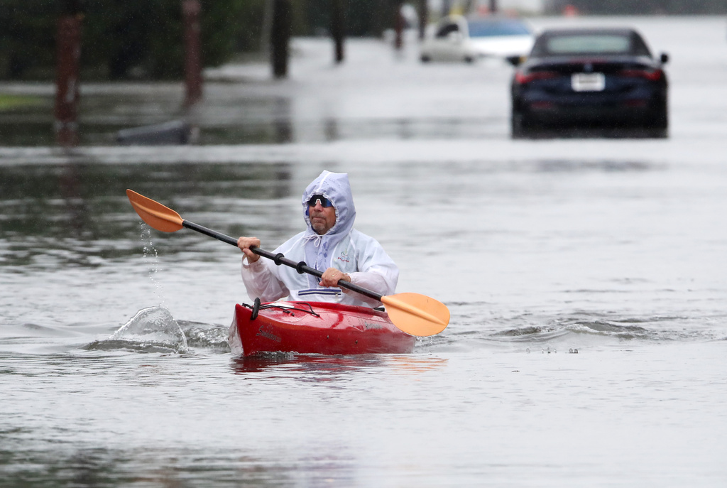 Ted Friedli kayaks his way through a flooded section of Florence Ave. during a nor'easter in Long Branch, N.J., Saturday, Sept. 26, 2026 (AP Photo/Noah K. Murray)