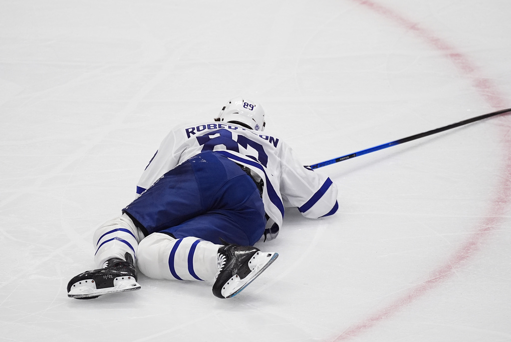 Toronto Maple Leafs left wing Nicholas Robertson lies on the ice after injuring his left leg in the first period of an NHL hockey game against the Colorado Avalanche, Monday, Jan. 12, 2026, in Denver. (AP Photo/David Zalubowski)