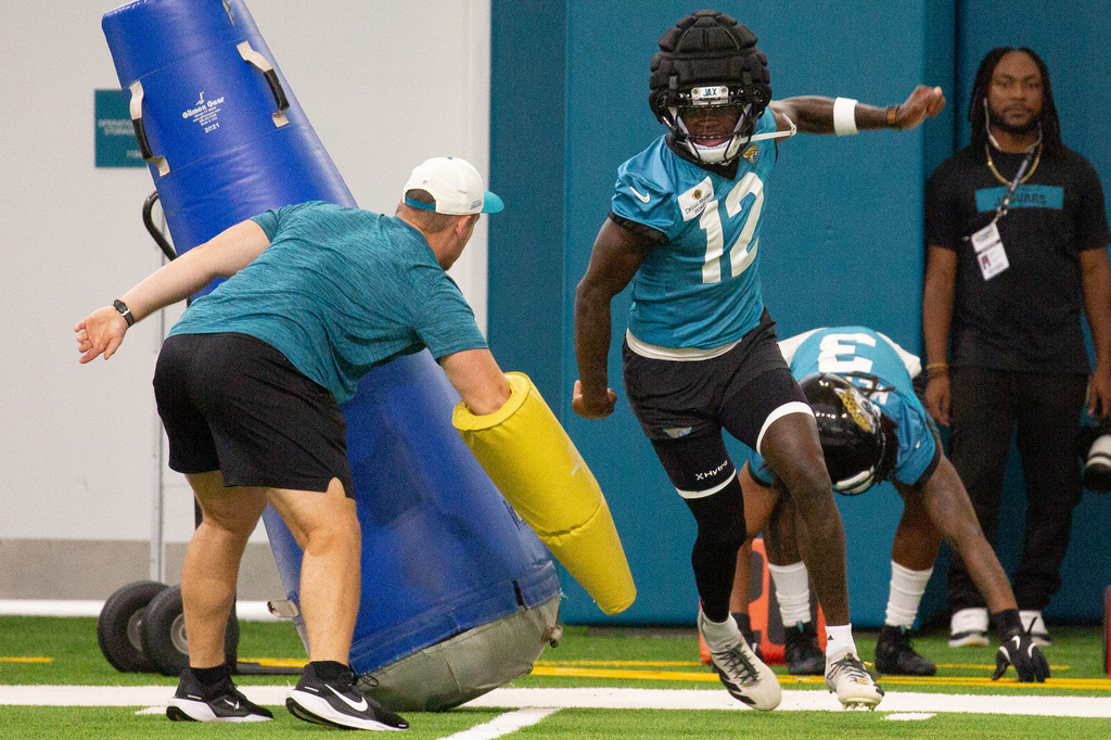 Jacksonville Jaguars wide receiver and cornerback Travis Hunter (12) particpates in drills during practice at the team's NFL football training camp, Thursday, July 30, 2026, in Jacksonville, Fla. (AP Photo/Kelly Jordan)