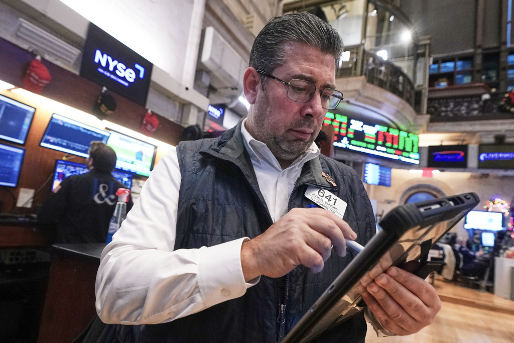 Trader Michael Capolino works on the floor of the New York Stock Exchange, Tuesday, Dec. 2, 2025. (AP Photo/Richard Drew)