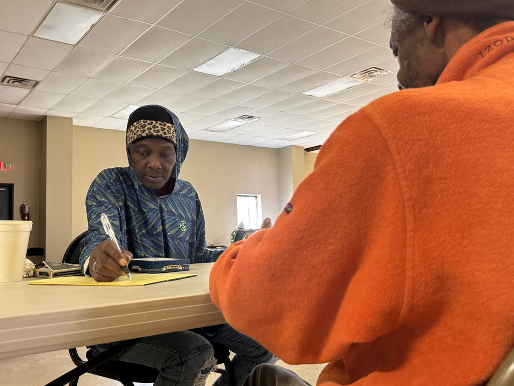 Sherry Miller, who is staying at the Humphreys County warming center, passes the time playing dominoes with others seeking shelter in Belzoni, Miss., on Thursday, Jan. 29, 2026. (AP Photo/Sophie Bates)