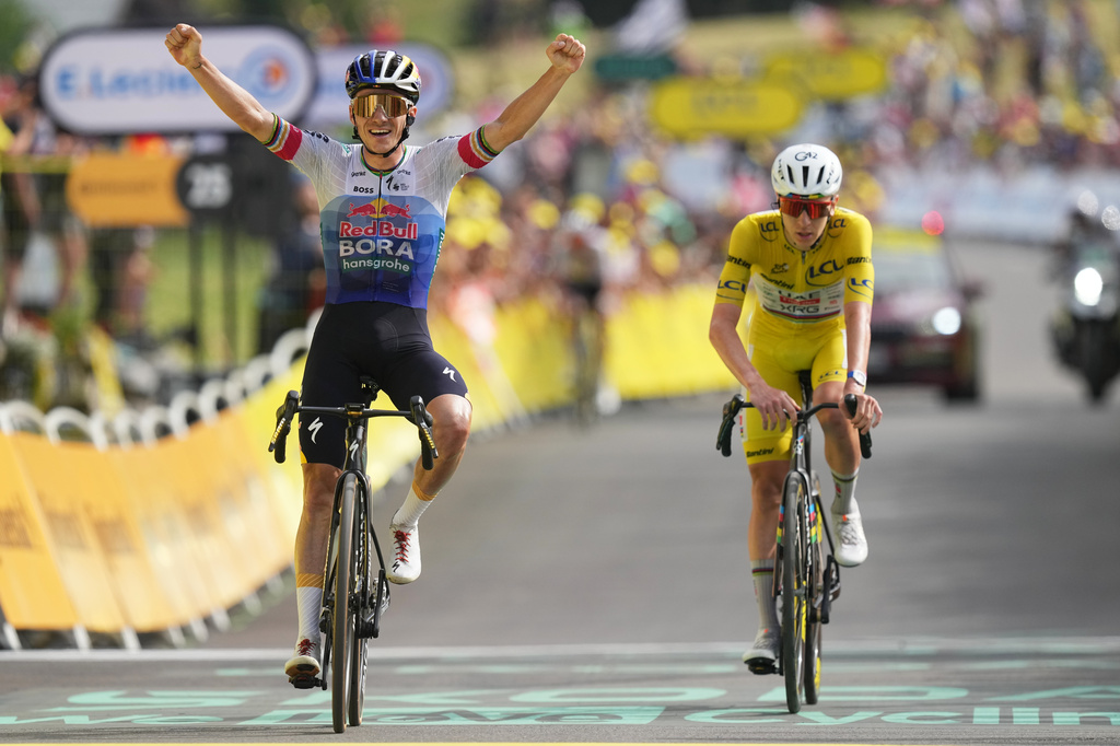 Belgium's Remco Evenepoel celebrates as he crosses the finish line ahead Slovenia's Tadej Pogacar to win the fifteenth stage of the Tour de France cycling race, from Champagnole to the Plateau de Solaison, France, Sunday, July 19, 2026. (AP Photo/Thibault Camus)