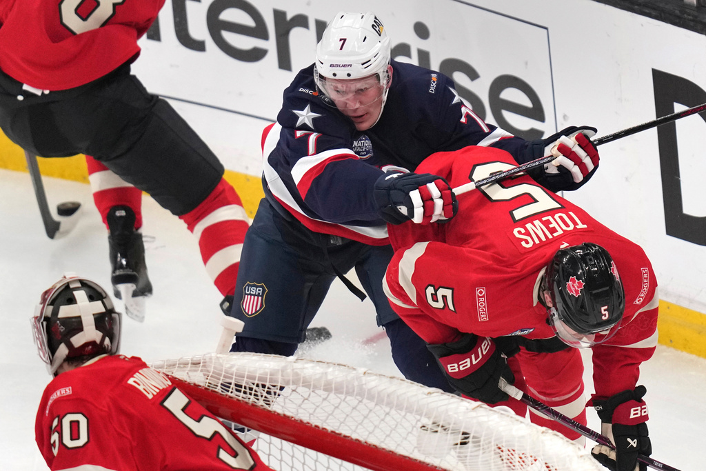 FILE - United States' Brady Tkachuk checks Canada's Devon Toews (5) during the first period of the 4 Nations Face-Off championship hockey game, Feb. 20, 2025, in Boston. (AP Photo/Charles Krupa, File)