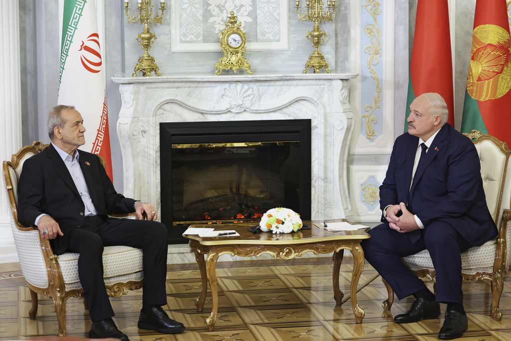 In this photo, released by Belarusian Presidential Press Service, Belarusian President Alexander Lukashenko, right, and Iranian President Masoud Pezeshkian talk to each other during their meeting in Minsk, Belarus, Wednesday, Aug. 20, 2025. (Belarusian Presidential Press Service via AP)