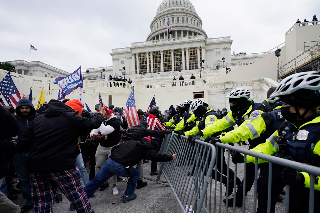 FILE - Violent insurrections loyal to President Donald Trump break through a police barrier at the Capitol in Washington on Jan. 6, 2021. (AP Photo/Julio Cortez, File)