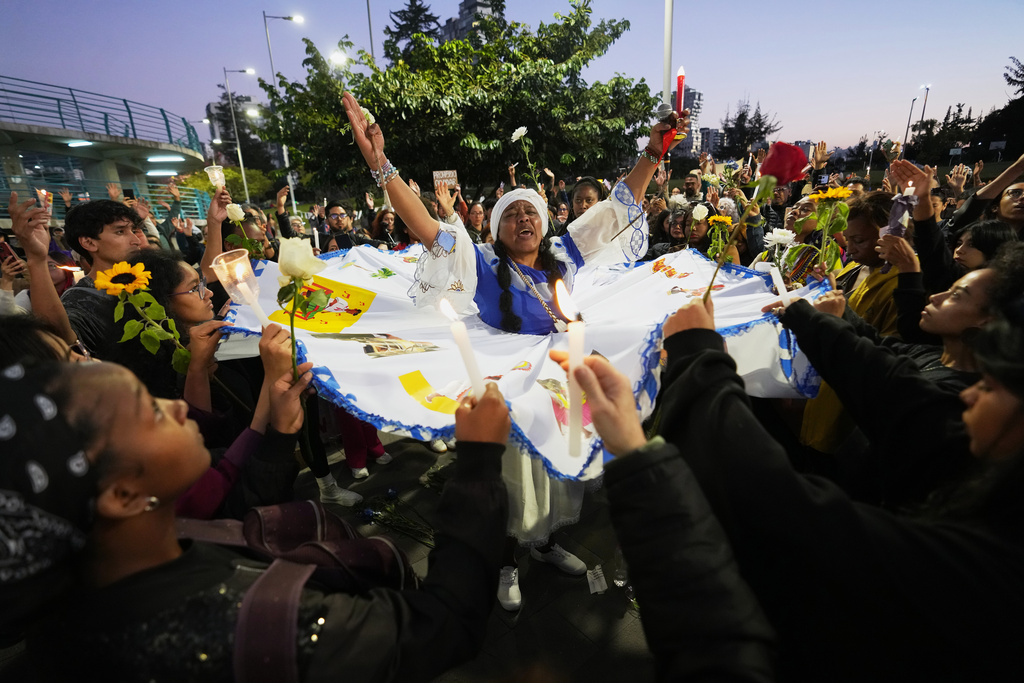 FILE - People take part in a ceremony in Quito, Ecuador, Dec. 8, 2025, to mark the anniversary of the alleged forced disappearance of four minors whose bodies were found in the port city of Guayaquil in late 2024. (AP Photo/Dolores Ochoa, File)