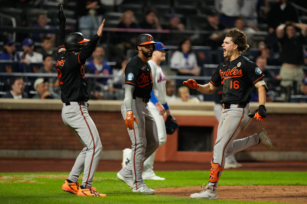 Baltimore Orioles' Coby Mayo, right, celebrates with Dylan Beavers, left, and Leody Taveras, center, after hitting a three-run home run during the eleventh inning of a baseball game against the New York Mets, Tuesday, Sept. 15, 2026, in New York. (AP Photo/Seth Wenig)