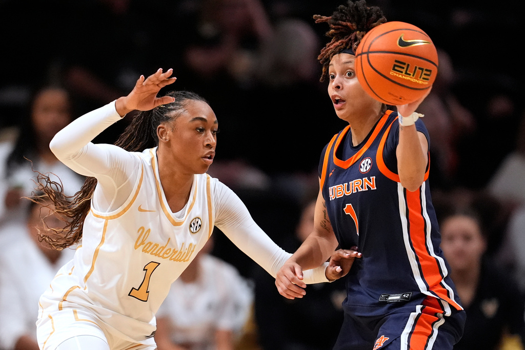 Auburn guard Mya Petticord (1) passes the ball around Vanderbilt guard Mikayla Blakes (1) during the first half of an NCAA college basketball game Thursday, Jan. 22, 2026, in Nashville, Tenn. (AP Photo/George Walker IV)