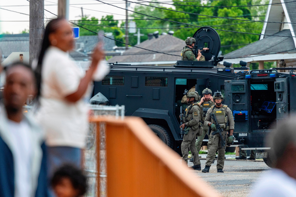 FILE - Residents watch as law enforcement search for a fugitive who escaped a prison in New Orleans, May 21, 2025. (Chris Granger/The Times-Picayune/The New Orleans Advocate via AP, File)