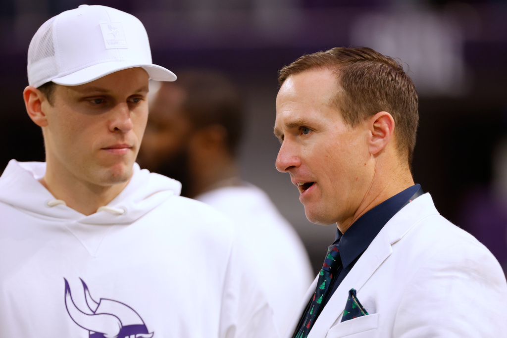 Former NFL quarterback Drew Brees, right, stands on the sidelines before an NFL football game between the Minnesota Vikings and the Detroit Lions, Thursday, Dec. 25, 2025, in Minneapolis. (AP Photo/Bruce Kluckhohn)