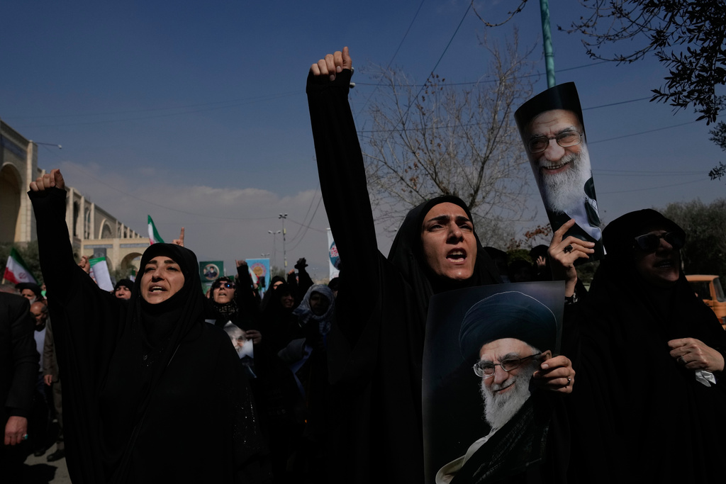Woman chant slogans while holding pictures of the late Iranian Supreme Leader Ayatollah Ali Khamenei as government supporters march against the ongoing U.S.-Israeli military campaign after their Friday prayers at the Imam Khomeini Grand mosque in Tehran, Iran, Friday, March 6, 2026. (AP Photo/Vahid Salemi)