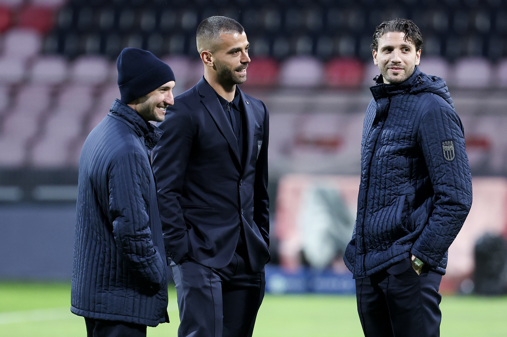From left to right, Italy's Matteo Politano, Leonardo Spinazzola, and Manuel Locatelli walk on the pitch ahead of Tuesday's World Cup playoff final soccer match against Bosnia, at the Bilino Polje stadium, in Zenica, Bosnia, Monday, March 30, 2026. (AP Photo/Armin Durgut)