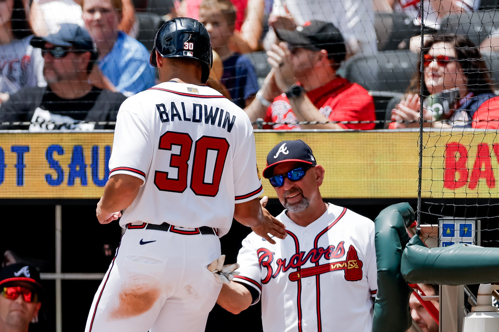 Atlanta Braves' Drake Baldwin (30) is greeted by manager Walt Weiss, right, after scoring against the Texas Rangers during the first inning of a baseball game, Sunday, July 19, 2026, in Atlanta. (AP Photo/Erik S. Lesser)