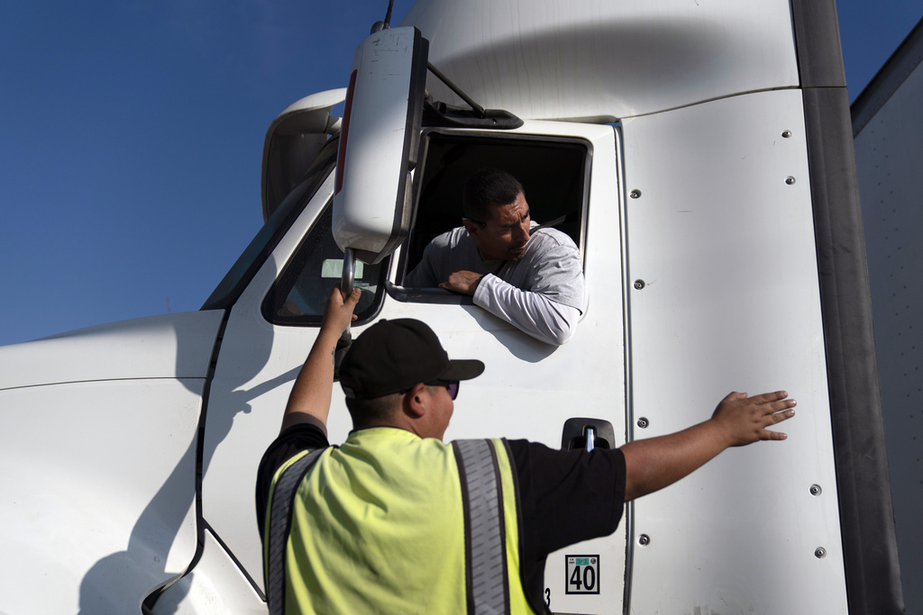 FILE - Senior instructor Markus Juarez, bottom, talks to student driver Jaime Rojas at California Truck Driving Academy in Inglewood, Calif., Wednesday, Nov. 17, 2021. (AP Photo/Jae C. Hong, File)