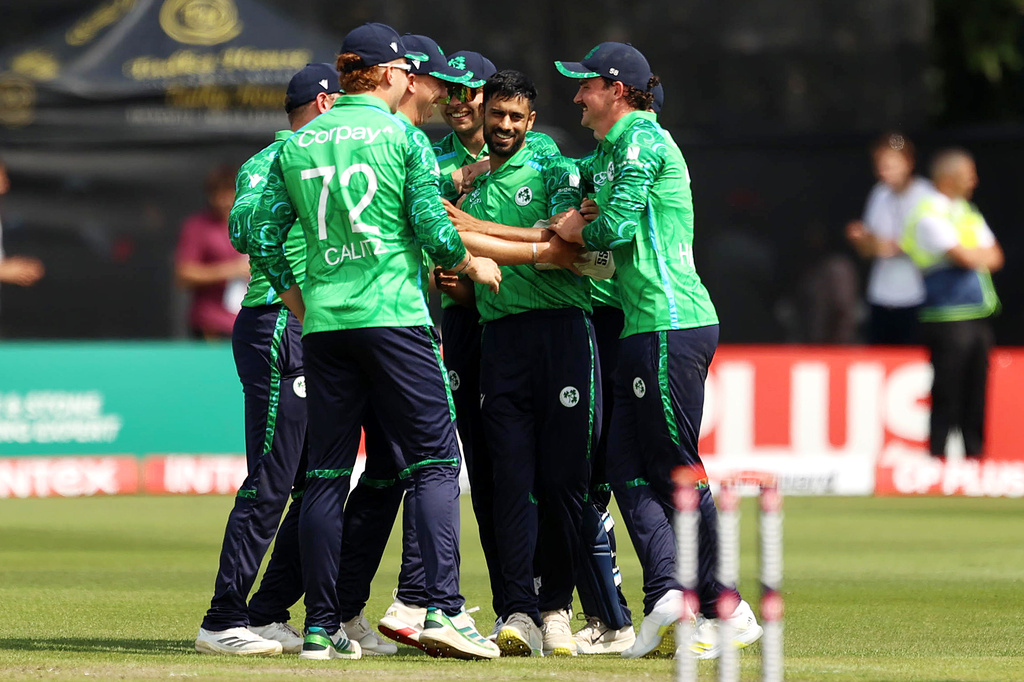 Ireland's Jai Moondra, center, celebrates with team-mates after bowling out India's Sanju Samson during the first T20I test match at Stormont, Belfast, Northern Ireland, Friday June 26, 2026. (Liam McBurney/PA via AP)
