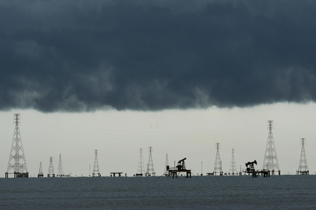 Clouds form over pumpjacks and power transmission towers on Lake Maracaibo in Cabimas, Venezuela, Tuesday, Sept. 1, 2026. (AP Photo/Ariana Cubillos)
