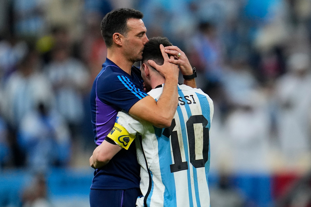 FILE - Argentina's head coach Lionel Scaloni kisses Argentina's Lionel Messi, right, at the end of the World Cup quarterfinal soccer match between the Netherlands and Argentina, at the Lusail Stadium in Lusail, Qatar, Dec. 10, 2022. (AP Photo/Natacha Pisarenko, File)