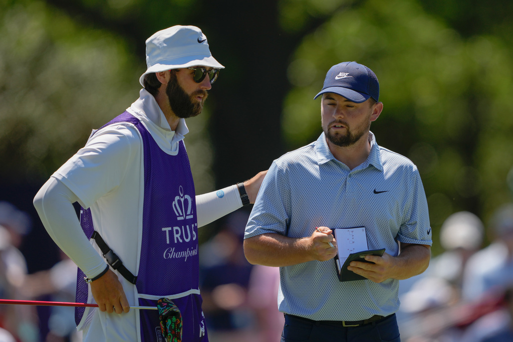 Alex Fitzpatrick, of England, reacts with his caddie after a birdie on the fifth hole during the final round of the Truist Championship golf tournament at the Quail Hollow Club, Sunday, May 10, 2026, in Charlotte, N.C. (AP Photo/Chris Carlson)