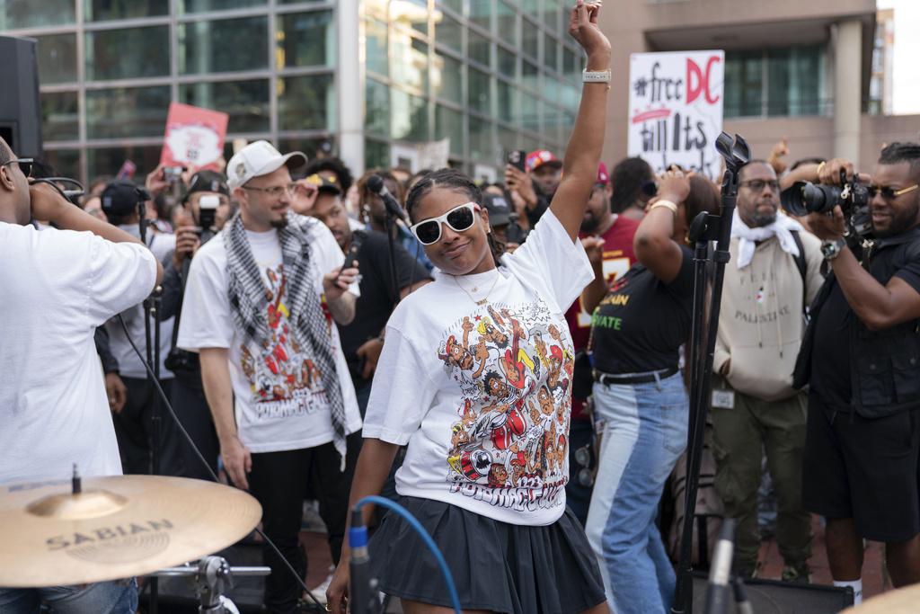 People protest with go-go music against President Donald Trump's use of federal law enforcement and National Guard troops along the U street corridor in northwest Washington Thursday, Aug. 21, 2025. (AP Photo/Jose Luis Magana)