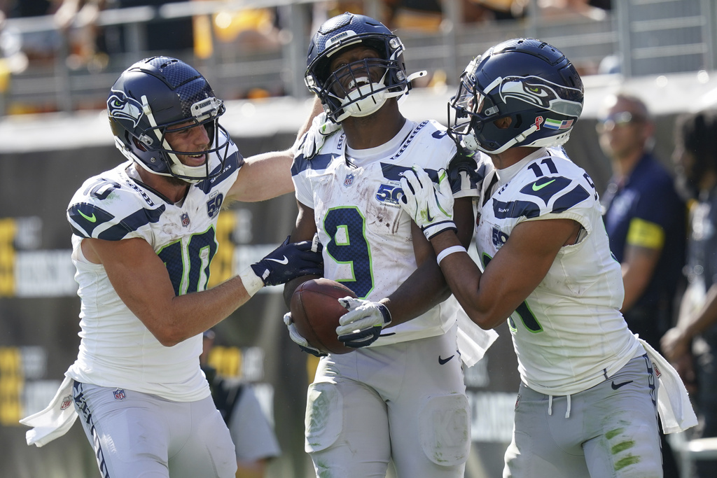 Seattle Seahawks running back Kenneth Walker III (9) celebrates a touchdown with wide receiver Cooper Kupp (10) and wide receiver Jaxon Smith-Njigba (11) during the second half of an NFL football game against the Pittsburgh Steelers, Sunday, Sept. 14, 2025, in Pittsburgh. (AP Photo/Matt Freed)