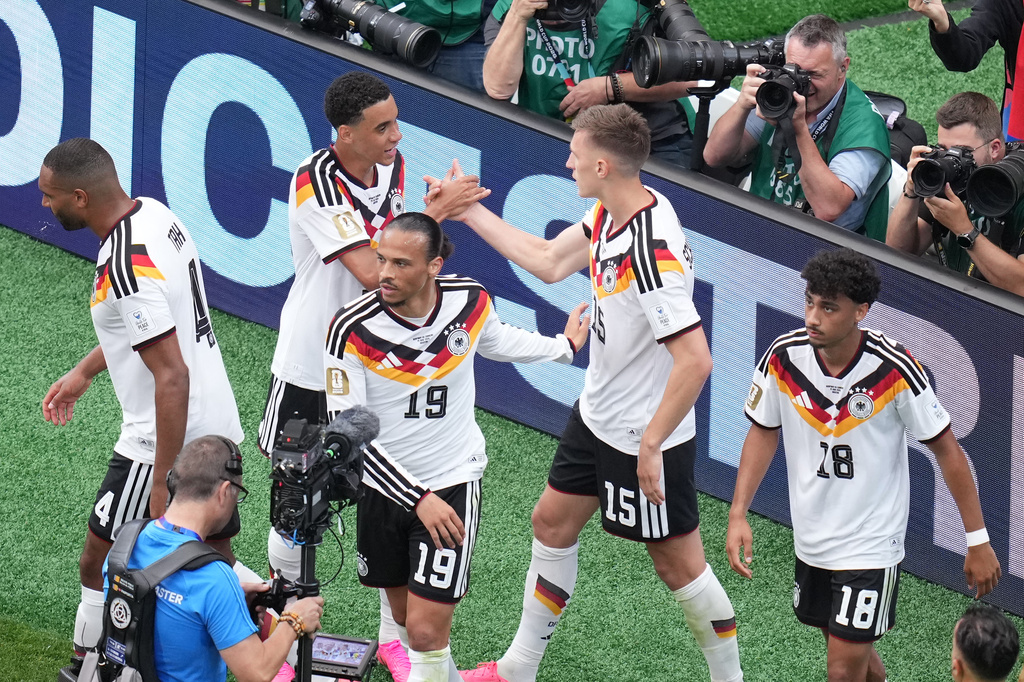 Germany's Nico Schlotterbeck (15) celebrates with teammates after scoring his side's second goal during the World Cup Group E soccer match between Germany and Curacao in Houston, Sunday, June 14, 2026. (AP Photo/Eric Smith)