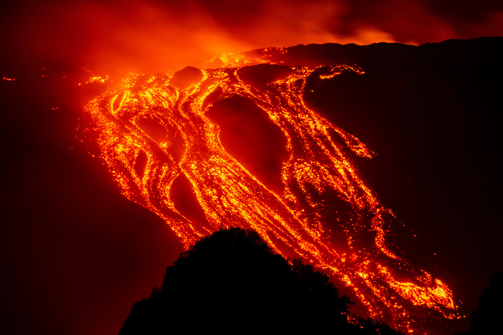 Eruptive activity continues on Mount Etna, where lava flows continue to descend on the slopes of the volcano, as seen from Mareneve near Catania, Italy, Thursday, Aug. 13, 2026. (AP Photo/Salvatore Allegra)