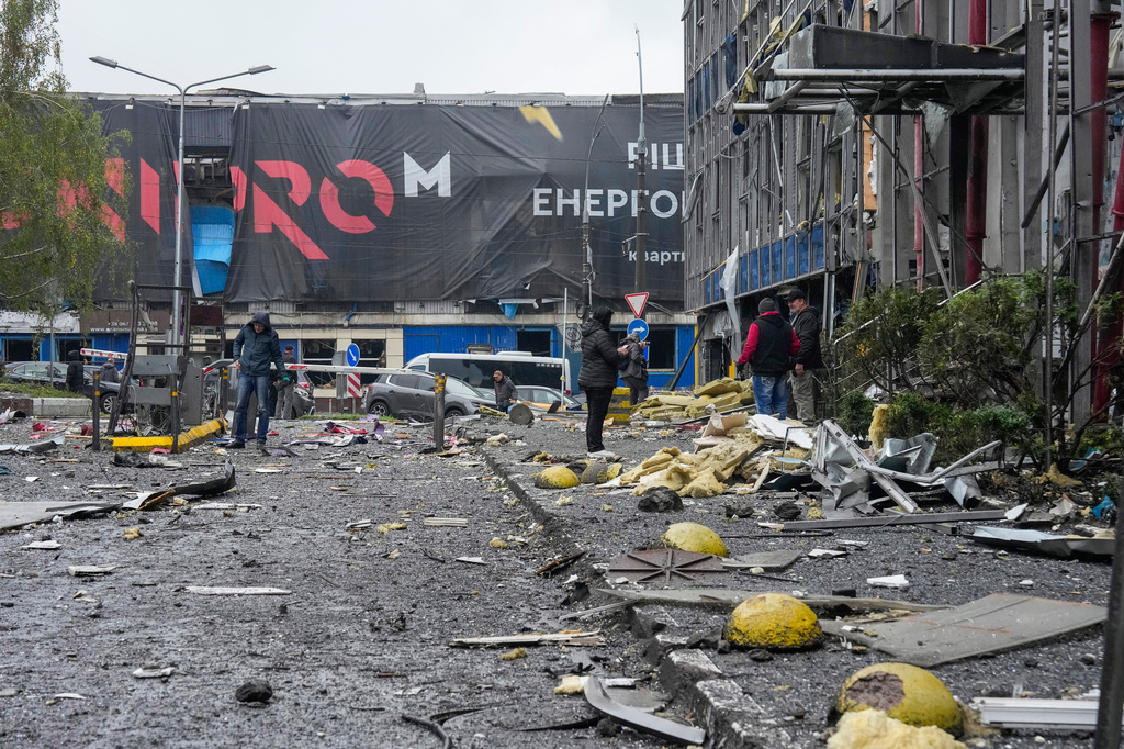 People look at damaged office center after a Russian missile attack in central Kyiv, Ukraine, Monday, Oct. 19, 2026. (AP Photo/Efrem Lukatsky)