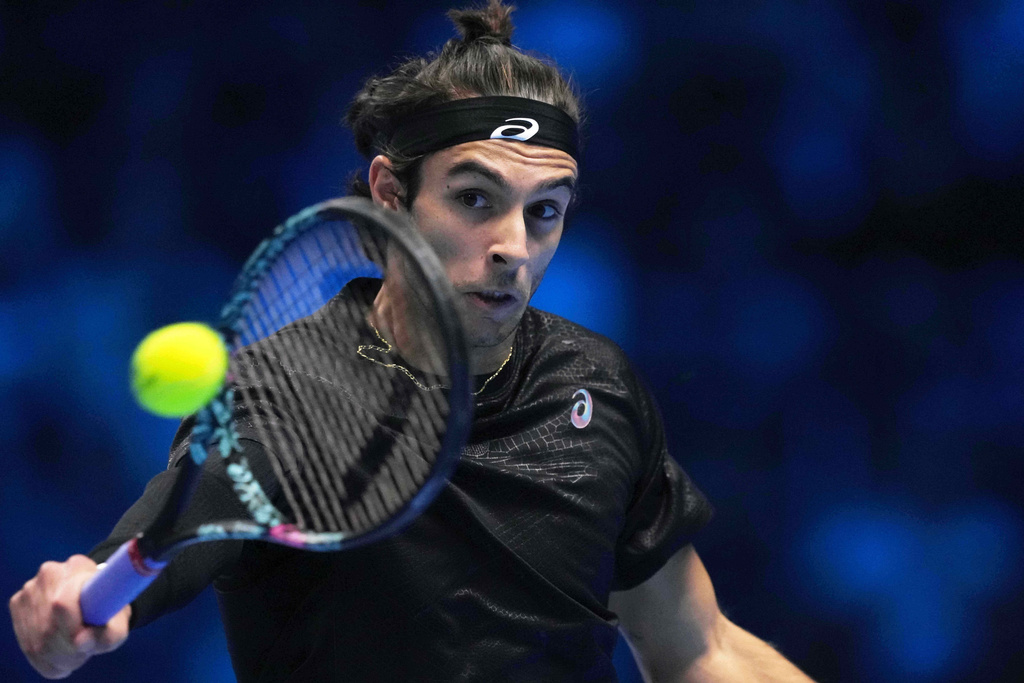 Italy's Lorenzo Musetti returns the ball to United States' Taylor Fritz during their singles tennis match of the ATP World Tour Finals, in Turin, Italy, Monday, Nov. 10, 2025. (AP Photo/Antonio Calanni)