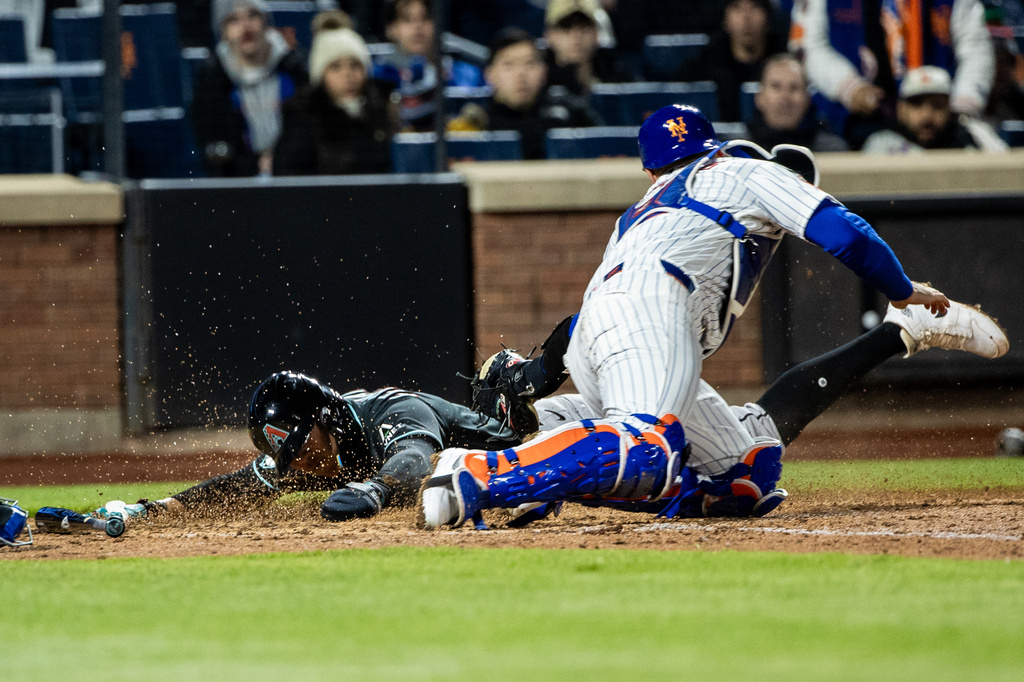Arizona Diamondbacks' Jose Fernandez, left, slides safely into home plate during the seventh inning of a baseball game against the New York Mets, Thursday, April 9, 2026, in New York. (AP Photo/Angelina Katsanis)