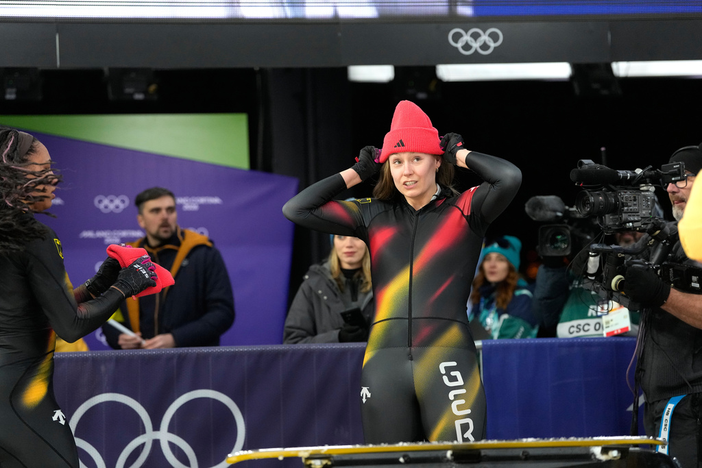 Germany's Laura Nolte reacts as she arrives at the finish during a two women bobsled run at the 2026 Winter Olympics, in Cortina d'Ampezzo, Italy, Friday, Feb. 20, 2026. (AP Photo/Alessandra Tarantino)