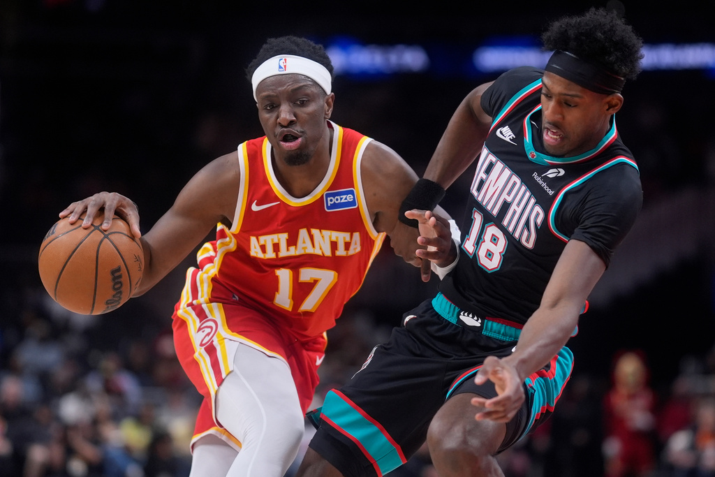 Atlanta Hawks forward Onyeka Okongwu (17) drives against Memphis Grizzlies forward Olivier-Maxence Prosper (18) during the first half of an NBA basketball game, Monday, March 23, 2026, in Atlanta. (AP Photo/Mike Stewart)