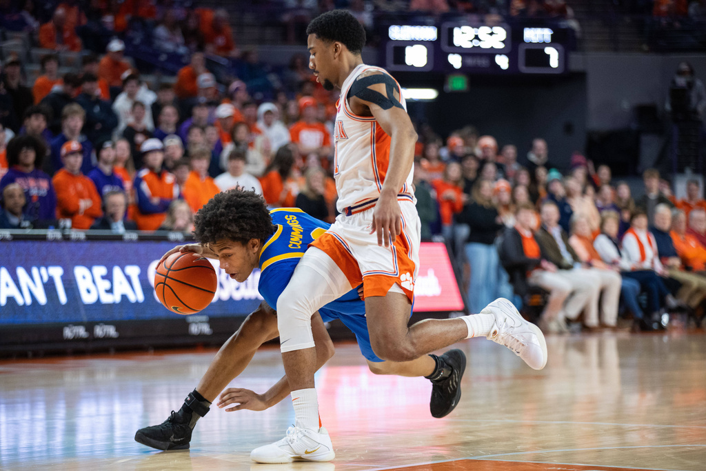 Pittsburgh guard Brandin Cummings (3) drives on Clemson guard Ace Buckner (21) during the first half of an NCAA college basketball game Saturday, Jan. 31, 2026, in Clemson, S.C. (AP Photo/Scott Kinser)