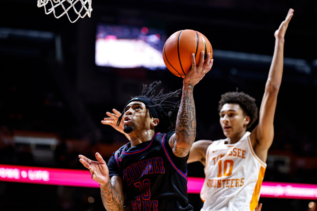 Tennessee State guard Dante Harris (10) shoots past Tennessee forward Nate Ament (10) during the second half of an NCAA college basketball game Thursday, Nov. 20, 2025, in Knoxville, Tenn. (AP Photo/Wade Payne)