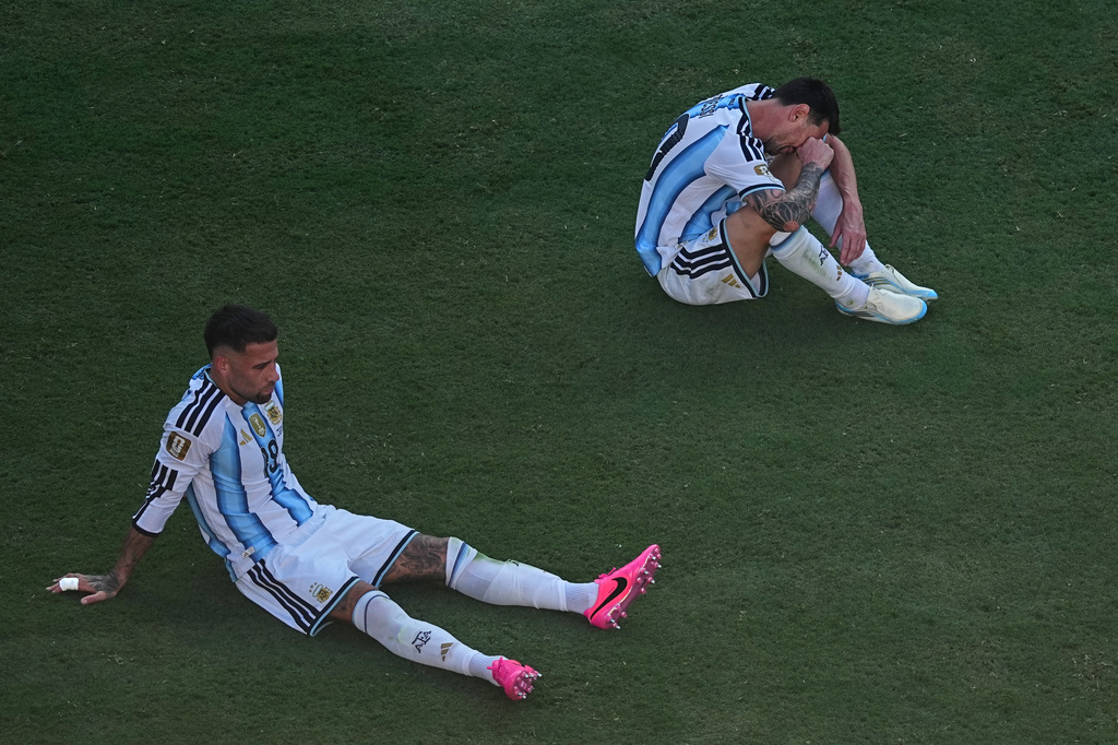 Argentina's Nicolas Otamendi (19) and Lionel Messi (10) sit dejected after during the World Cup final soccer match between Spain and Argentina in East Rutherford, N.J., near New York, Sunday, July 19, 2026. (AP Photo/Matt Rourke)
