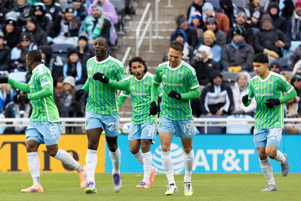 Seattle Sounders players celebrate after scoring against Minnesota United during the first half of Game 3 in the first round of MLS soccer's Western Conference playoffs in St. Paul, Minn., Saturday, Nov. 8, 2025. (AP Photo/Ellen Schmidt)