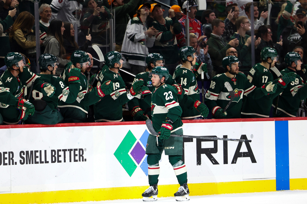 Minnesota Wild center Marco Rossi (23) celebrates at the bench after scoring a goal during the second period of an NHL hockey game against the Vancouver Canucks, Saturday, Nov. 1, 2025, in St. Paul, Minn. (AP Photo/Ellen Schmidt)