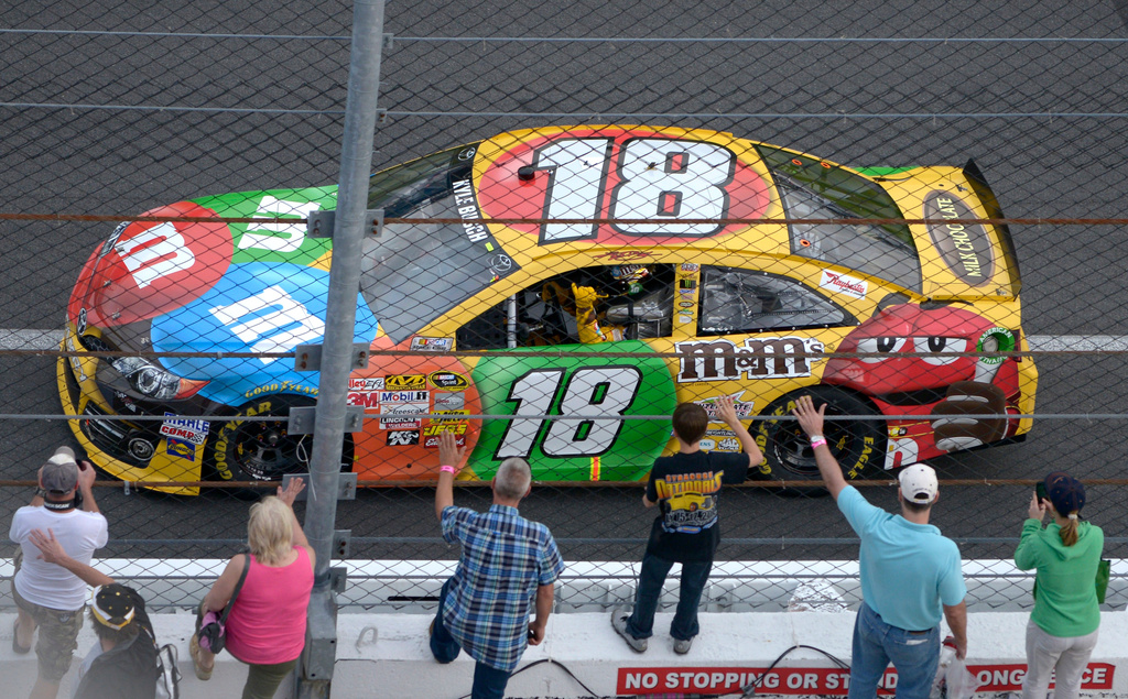 FILE - Kyle Busch waves to fans while doing a victory lap after winning the second of two 150-mile qualifying races for Sunday's NASCAR Daytona 500 auto race at Daytona International Speedway in Daytona Beach, Fla., Feb. 21, 2013. (AP Photo/Phelan M. Ebenhack, File)