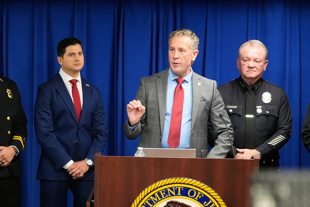 Special Agent in Charge Kenny Cooper, of the Bureau of Alcohol, Tobacco, Firearms and Explosives, Los Angeles Field Division, middle, speaks between Acting U.S. Attorney Bill Essayli, left, and Los Angeles Police Chief Jim McDonnell, right, during a news conference announcing an arrest made in the Palisades Fire, Wednesday, Oct. 8, 2025, in Los Angeles. (AP Photo/Damian Dovarganes)