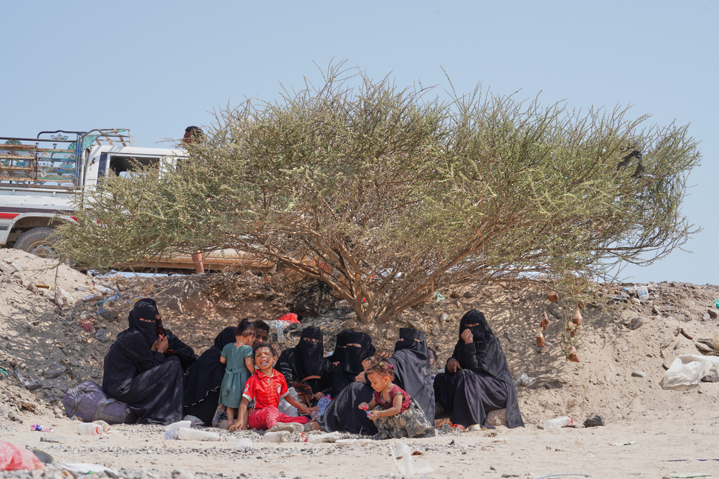 Displaced Yemenis sit outside at Al-Firdaws camp in Ras Imran, on the western outskirts of Aden, Yemen, Thursday, Sept. 24, 2026. (AP Photo/Abdulnasser Alseddik)
