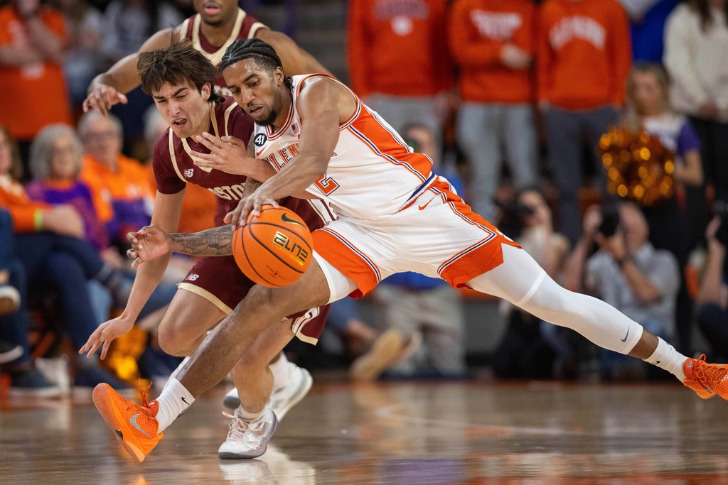 Clemson guard Dillon Hunter (2) beats Boston College guard Luka Toews (10) to the loose ball during the first half of an NCAA college basketball game Tuesday, Jan. 13, 2026, in Clemson, S.C. (AP Photo/Scott Kinser)