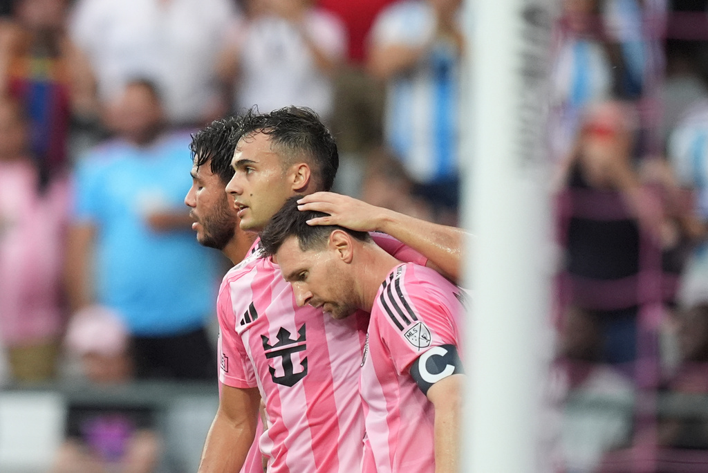 Inter Miami midfielder Leo Messi, front, is congratulated by defender Sergio Reguilon, second left, after scoring against the Portland Timbers during the first half of an MLS soccer match, Sunday, May 17, 2026, in Miami. (AP Photo/Rebecca Blackwell)