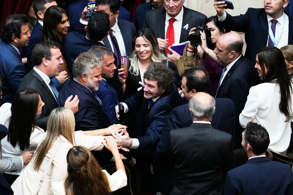 Argentina's President Javier Milei smiles while greeting lawmakers after delivering the annual State of the Nation address at Congress in Buenos Aires, Argentina, Sunday, March 1, 2026. (AP Photo/Gustavo Garello)