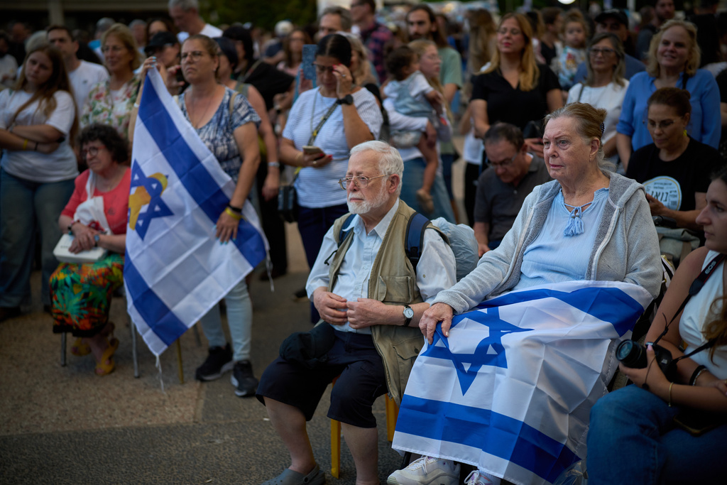 Attendees listen to a concert at a plaza known as hostages square, in Tel Aviv, Israel, Sunday, Oct. 12, 2025. (AP Photo/Emilio Morenatti)