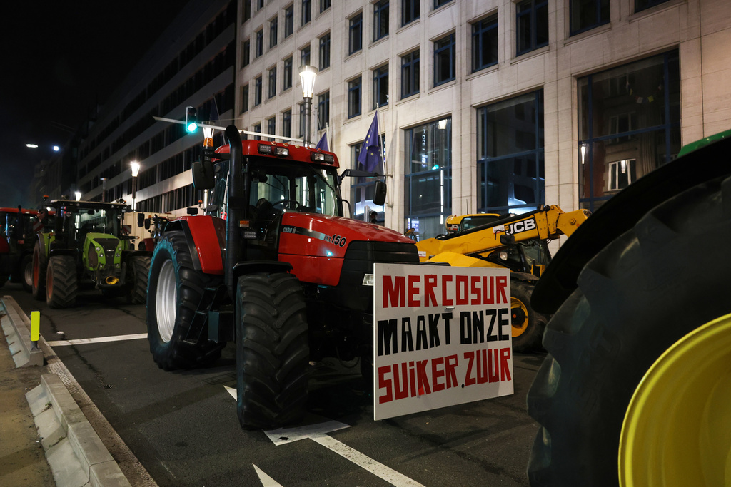 Farmers use their tractors to block a main road during a demonstration outside a gathering of European leaders at the EU Summit in Brussels, Thursday, Dec. 18, 2025. (AP Photo/Omar Havana)