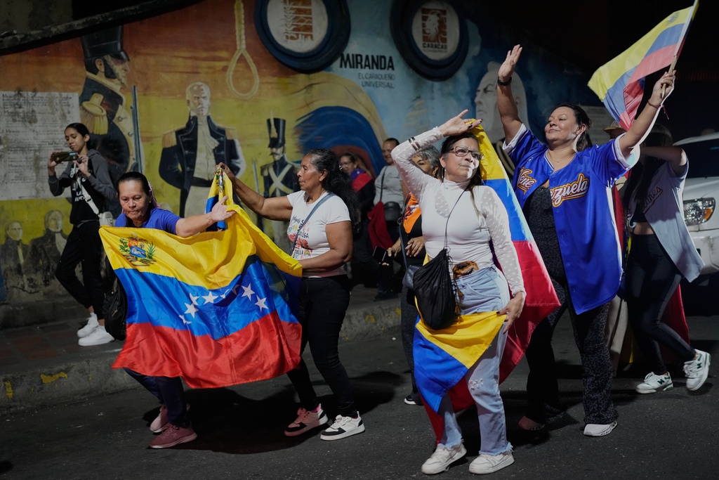 Venezuela fans celebrate their country's win against the United States in the championship match of the World Baseball Classic a day prior, in Caracas, Venezuela, Wednesday, March 18, 2026. (AP Photo/Ariana Cubillos)