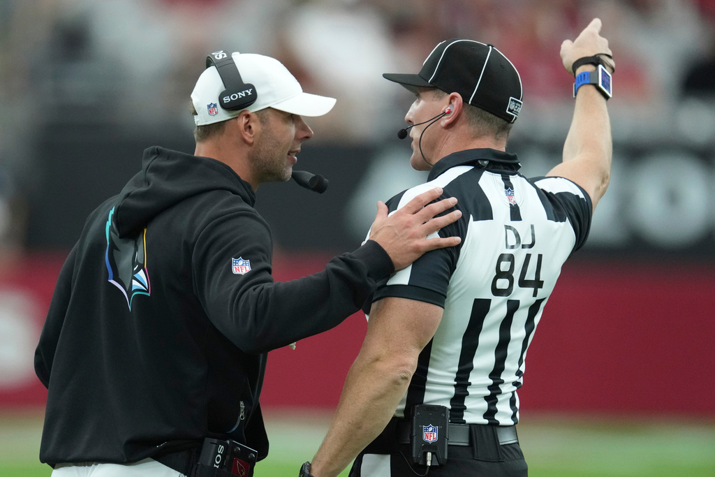 Arizona Cardinals head coach Jonathan Gannon talks to an official during the second half of an NFL football game against the Tennessee Titans, Sunday, Oct. 5, 2025, in Glendale, Ariz. (AP Photo/Ross D. Franklin)