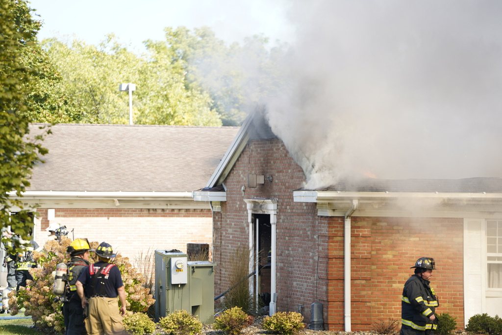 Emergency responders work the scene outside The Church of Jesus Christ of Latter-day Saints following a shooting and fire in Grand Blanc, Mich., Sunday, Sept. 28, 2025. (Lukas Katilius/The Flint Journal via AP)