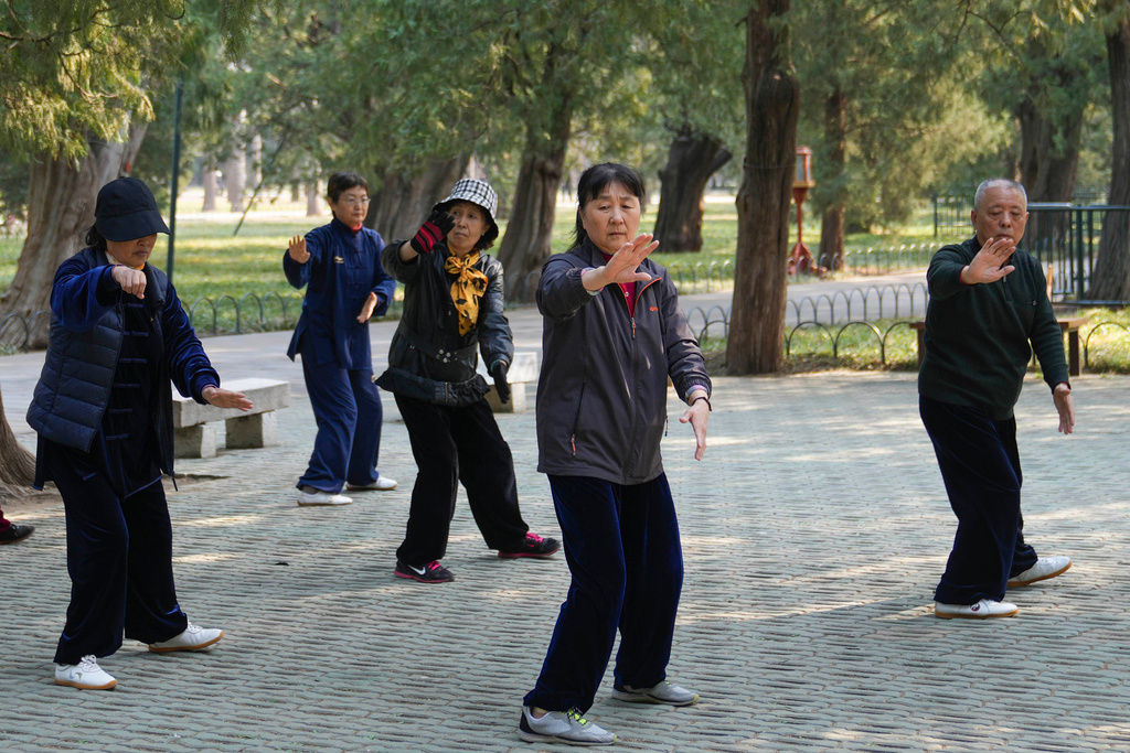 FILE - People exercise at a park near the Temple of Heaven in Beijing on April 2, 2024.(AP Photo/Tatan Syuflana, File)
